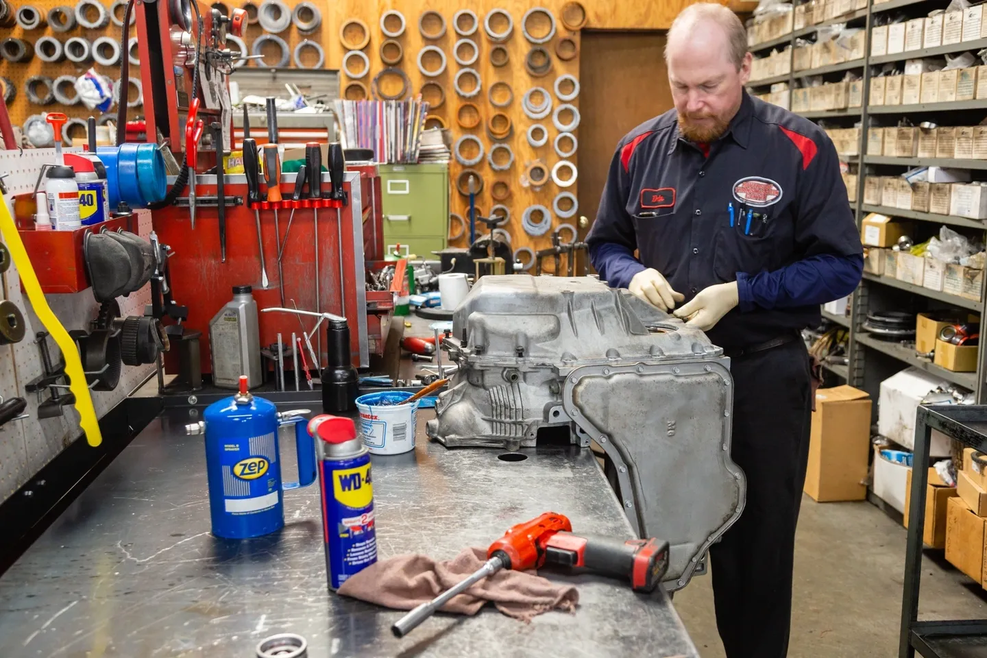 A man working on an engine in a shop.